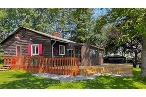 Stunning 100 x 145 waterfront cottage on Pigeon Lake featuring a level lot with its own private boat launch.