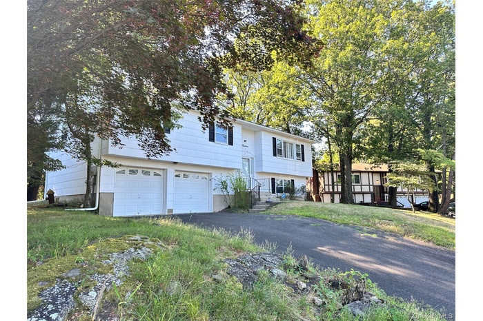 Split foyer home with driveway and a garage