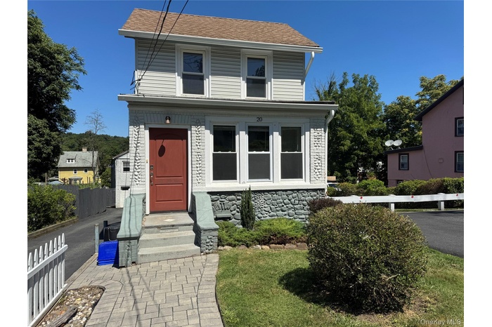 View of front of home featuring stone siding and a shingled roof