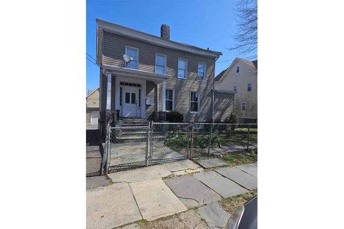 View of front of house with a gate, a chimney, and a fenced front yard