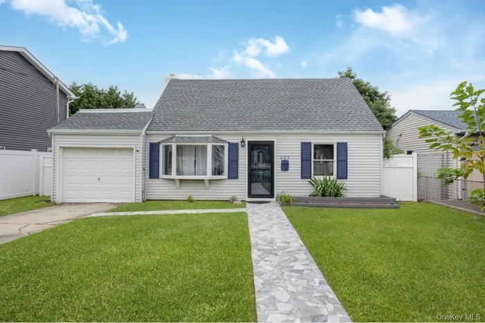 View of front of house featuring a shingled roof, a garage, and concrete driveway