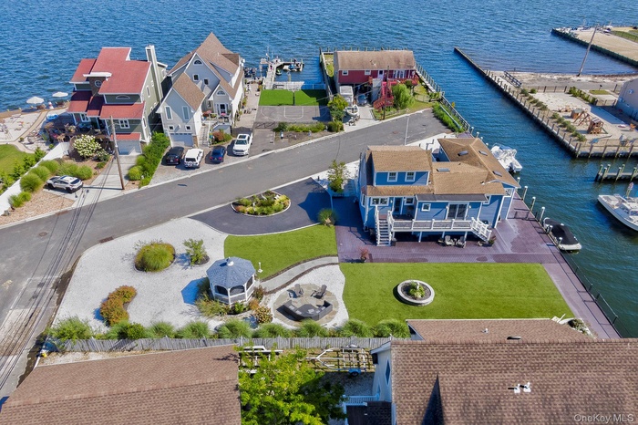 Aerial perspective of suburban area featuring a nearby body of water