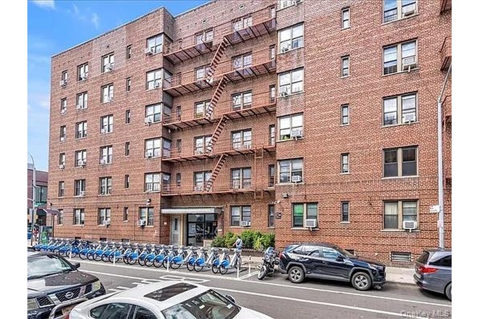 View of apartment building / complex featuring cooling unit