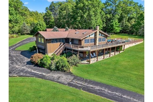 Set high on a rolling hilltop, this stunning contemporary ranch offers panoramic views that stretch for miles.