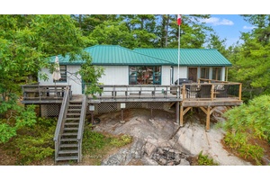 Set on a private 1. 49 acre landscape of granite outcrops and windswept pines, this classic Muskoka escape commands sweeping views over Paradise Bay on Go Home Lake.