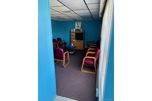 Office building with 4 rooms, 2 baths, reception area and waiting room.