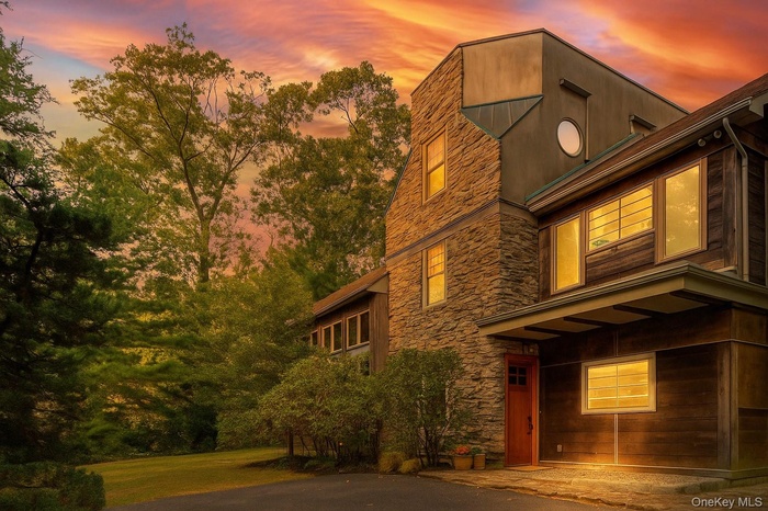 Property exterior at dusk with stone siding