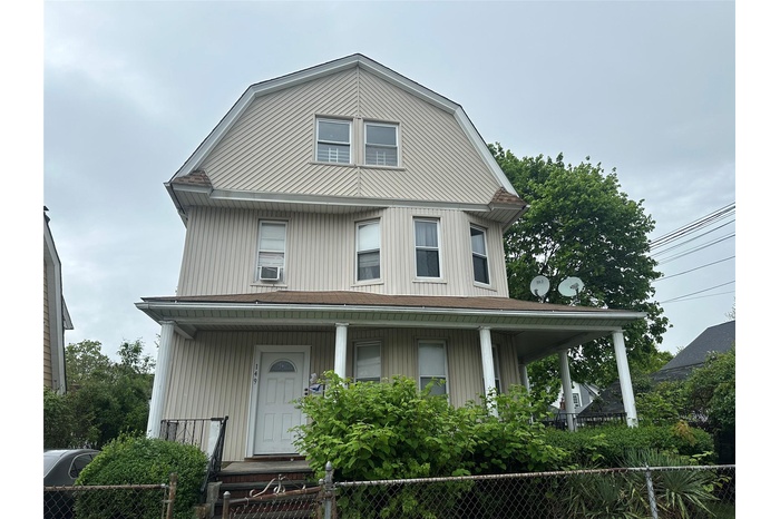 View of front of house featuring cooling unit, a porch, and fence