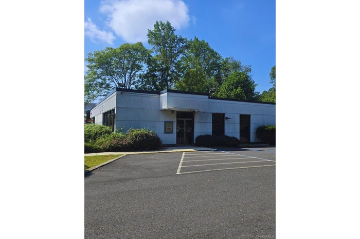 View of property featuring uncovered parking