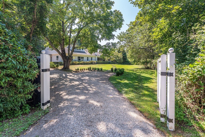 View of property hidden behind natural elements with a gate