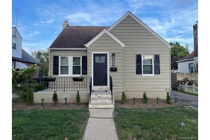 THIS BEAUTIFUL RENOVATED HOME SITS ON A QUIET TREE LINED STREET IN THE HEART OF FRANKLIN SQUARE !