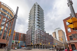 Bright 1 bedroom suite featuring large windows, a modern kitchen with integrated appliances, and convenient in suite laundry.