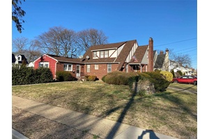 Welcome to this classic brick Tudor, offering timeless character and incredible space.