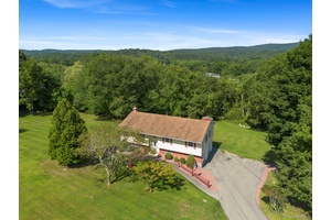 Nestled on an acre of green landscaped property sits a charming, spacious raised ranch.
