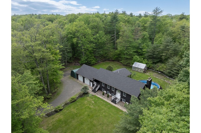 View of subject property featuring a heavily wooded area