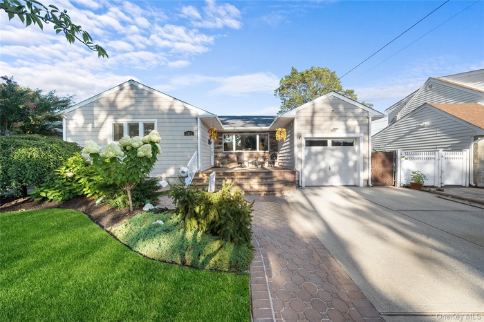 Ranch-style house featuring concrete driveway and a garage
