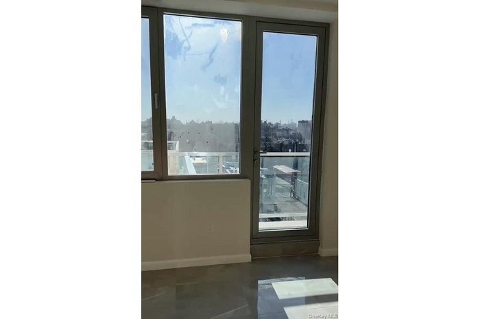 Doorway with a view of city and concrete flooring