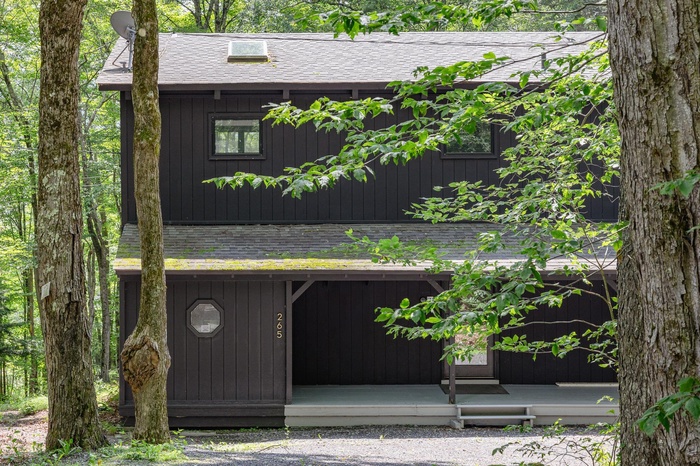 View of front facade with roof with shingles