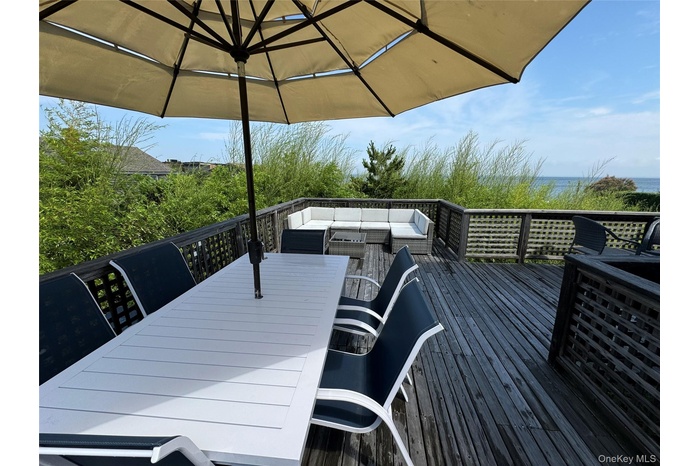 Wooden deck featuring an outdoor hangout area and outdoor dining area