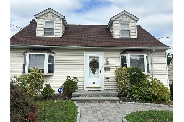 View of front of house featuring a shingled roof