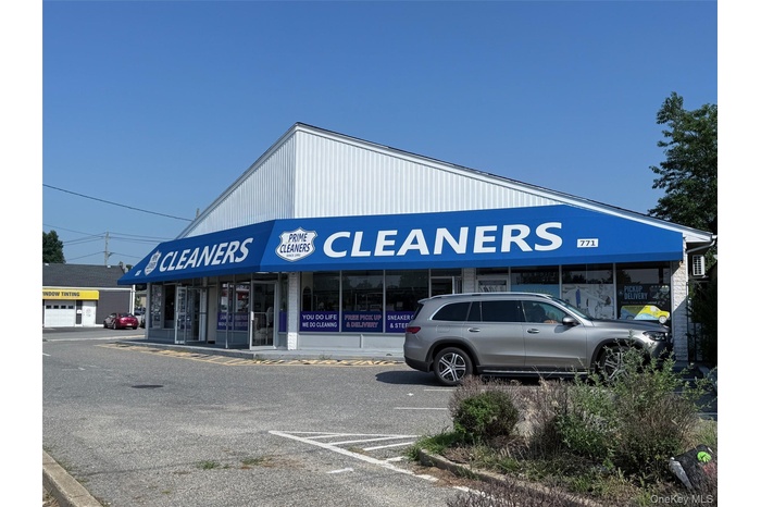 View of commercial property featuring uncovered parking