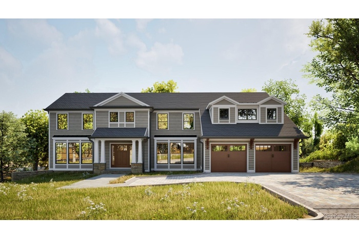 View of front of house featuring decorative driveway, a front lawn, and a garage