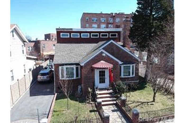 View of front of property with a fenced front yard and driveway