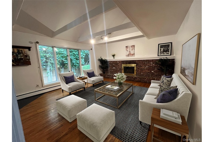 Beautiful living room with vaulted ceilings , fireplace and bay window
