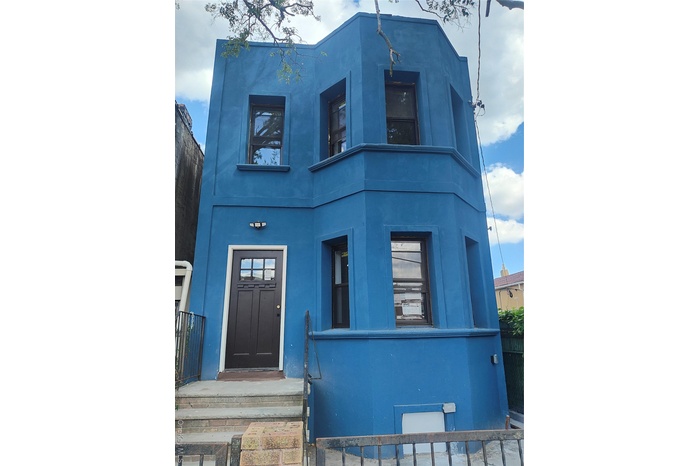Property entrance featuring stucco siding