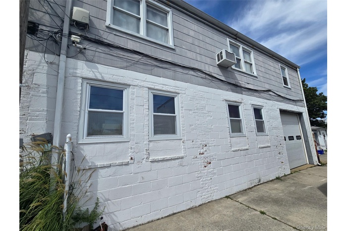 View of front facade with a fenced front yard and a chimney