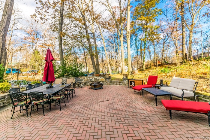 View of patio with an outdoor fire pit