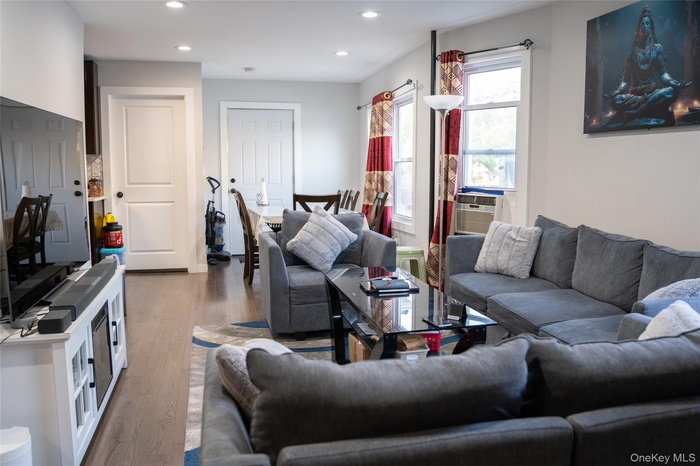 Living room featuring wood finished floors and recessed lighting