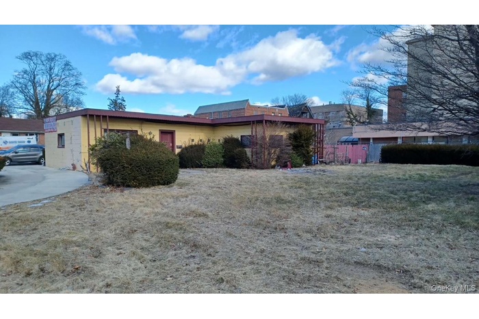 View of side of home with concrete block siding