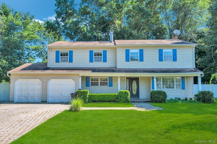 View of front of property featuring decorative driveway and roof with shingles