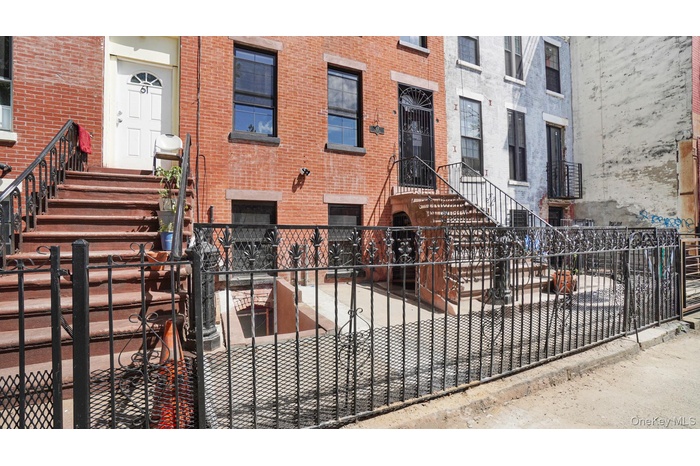 View of front of home featuring a fenced front yard, a gate, and brick siding