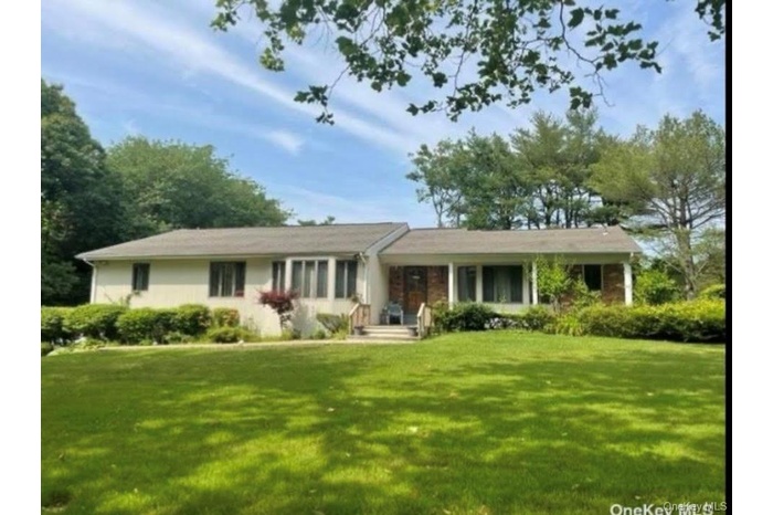 Single story home featuring a front lawn and covered porch