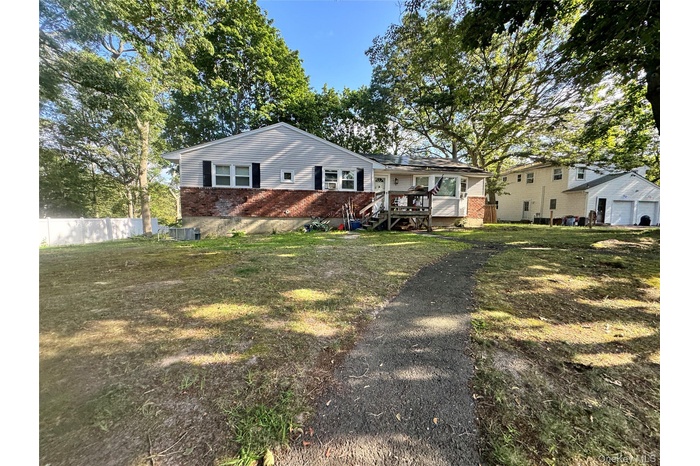 View of front facade featuring brick siding and a deck