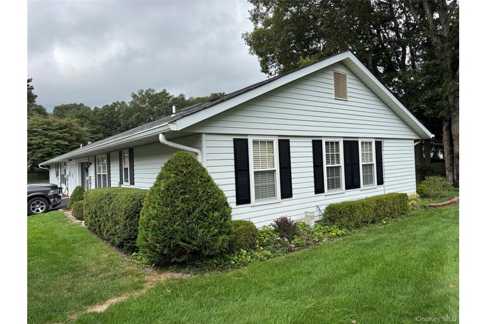 View of side of property featuring a yard