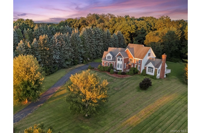 Aerial view at dusk , long driveway , flat level parcel, end of cul-de-sac.