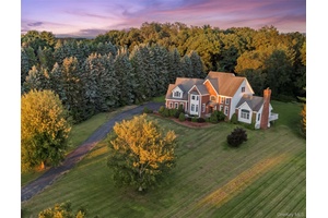 Welcome to 14 Kari Blvd, a classically elegant brick Colonial home that spans over 7, 000 finished square feet.