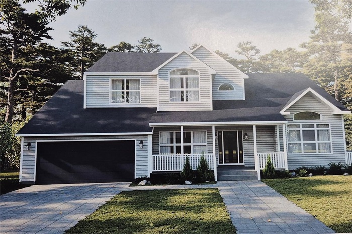 View of front of property with driveway, covered porch, and a front lawn
