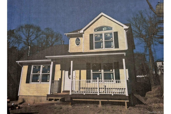 Traditional-style home featuring covered porch