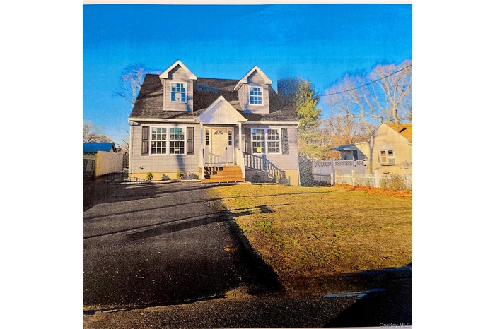Cape cod home with fence and a front yard