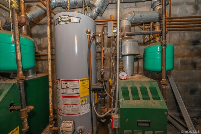 Utility room with water heater and a heating unit