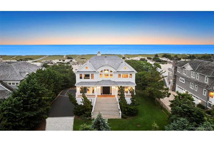 View of front of house featuring stairway, covered porch, a chimney, and a water view