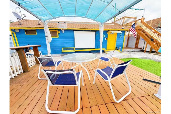 Wooden deck with a patio area and stairs