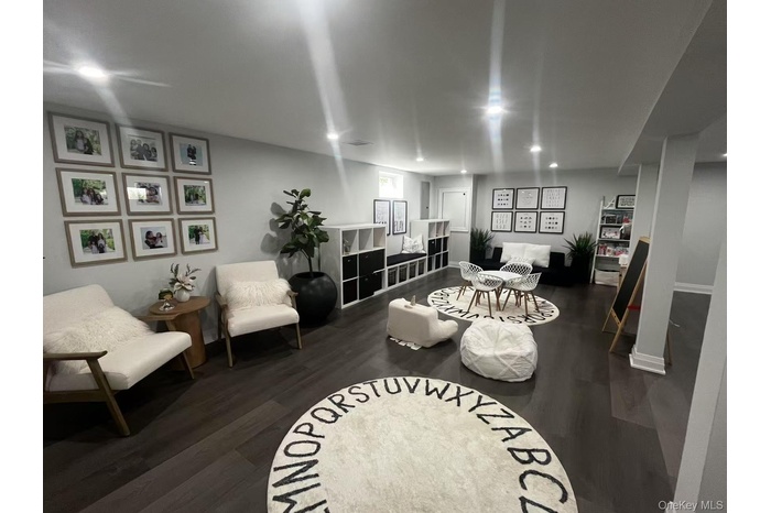 Living area with dark wood-style floors and recessed lighting