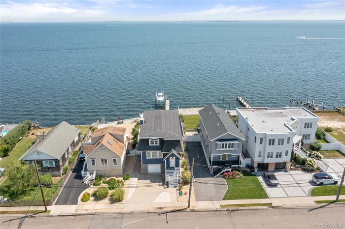 Aerial perspective of suburban area with a large body of water