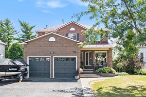 This sophisticated home is sure to impress, and its spacious foyer with circular hardwood staircase is a great start !