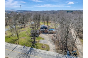 Nestled on nearly two acres and backing directly onto the serene Thames River, this stunning two story home offers the perfect blend of town convenience and country tranquility.